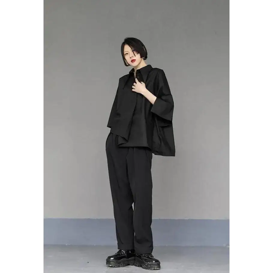 Black shirt with asymmetrical design and mid-length sleeves