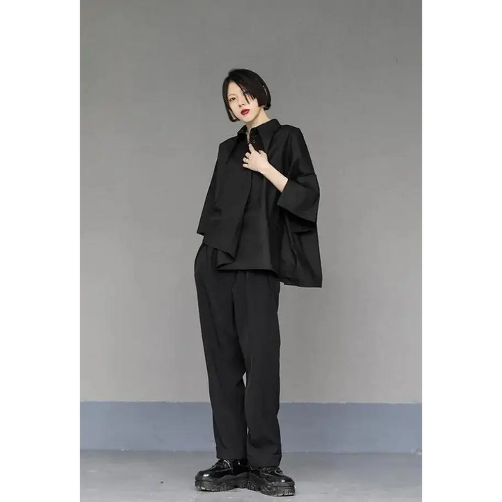 Black shirt with asymmetrical design and mid-length sleeves