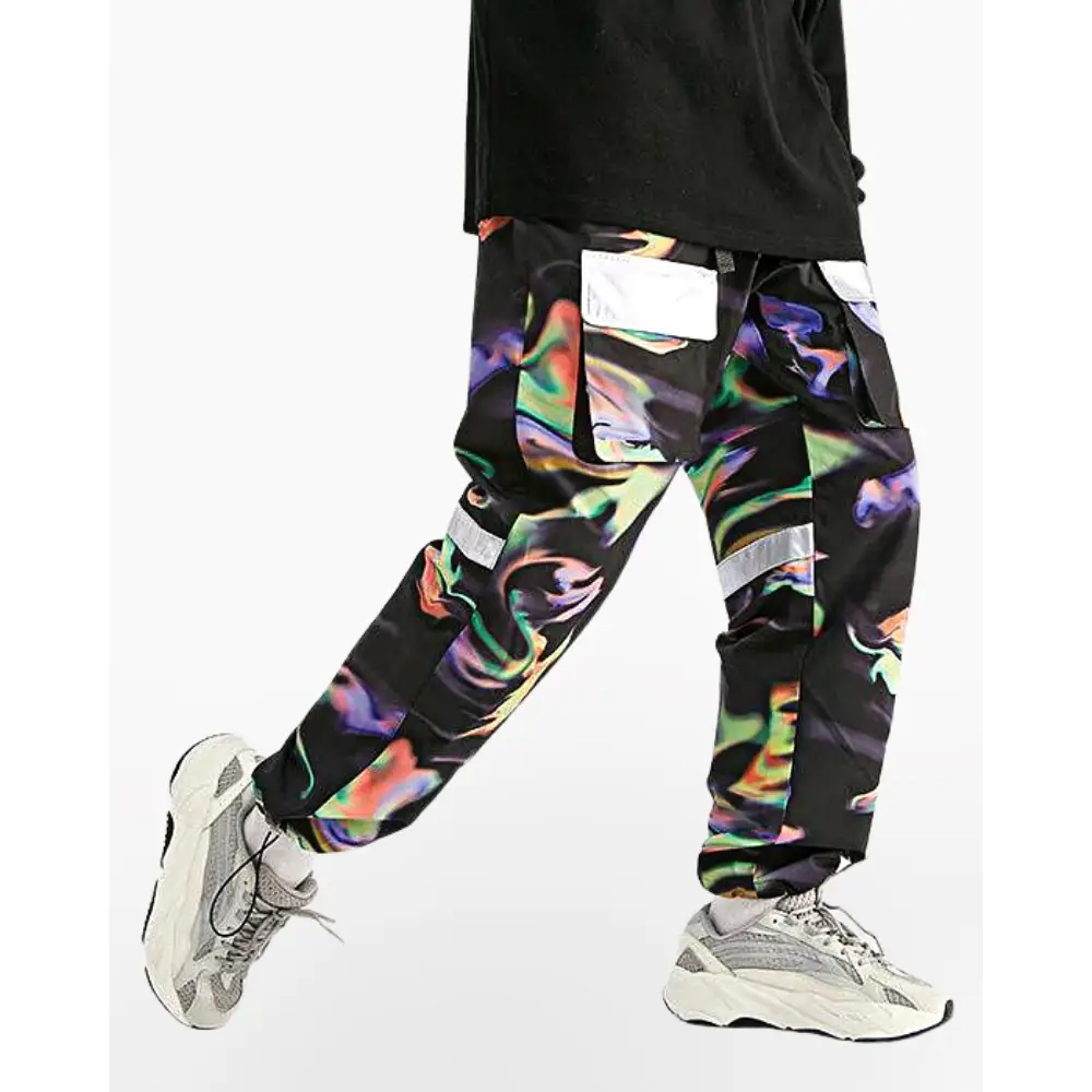 a man wearing a black shirt and colorful pants