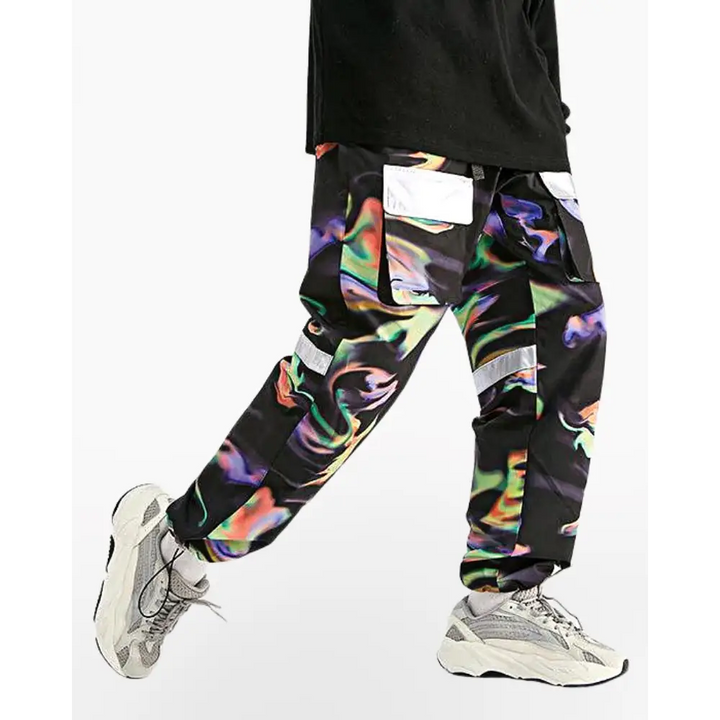 a man wearing a black shirt and colorful pants