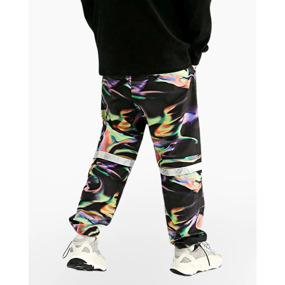 a man wearing a black sweatshirt and colorful pants