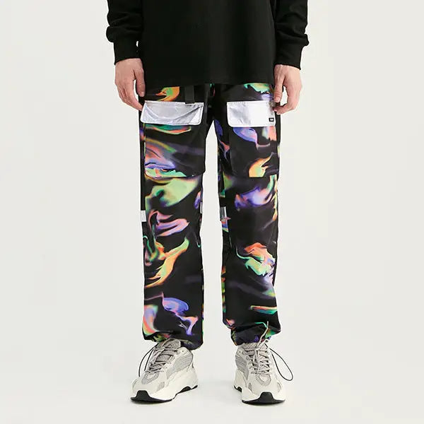 a man wearing a black sweatshirt and colorful pants