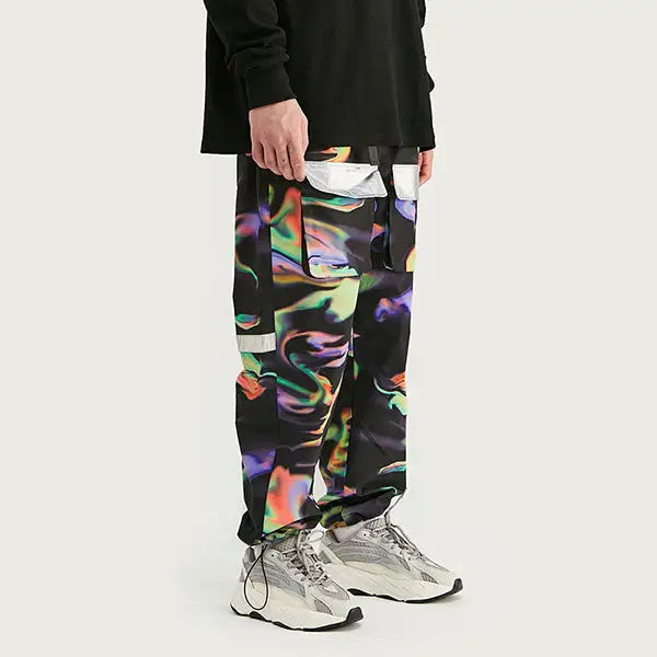 a man wearing a black sweatshirt and colorful pants