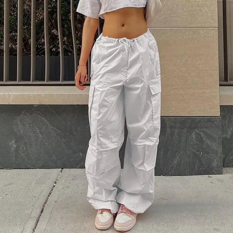 a woman dressed in white pants and a white top