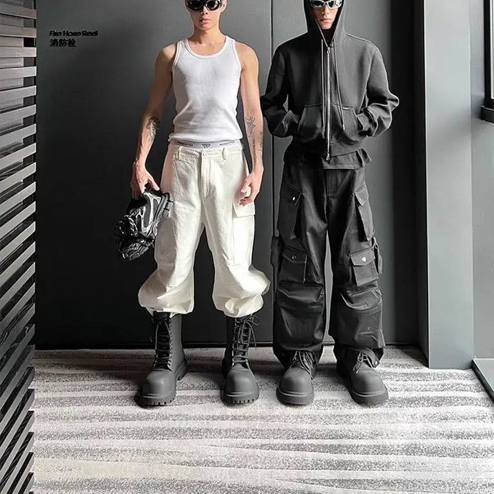 a man and a woman in white pants and black boots