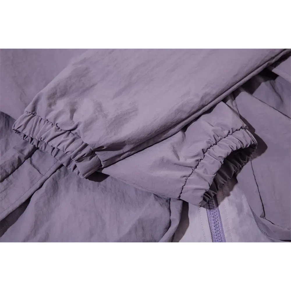 gros plan d’un lit avec une couette violette et un oreiller blanc