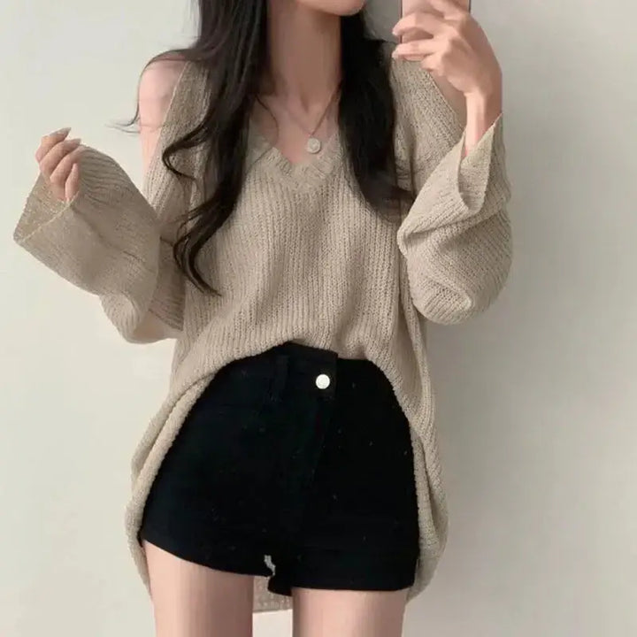 Loose knit sweater with cut-out shoulders and v-neckline