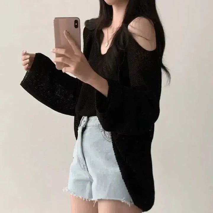 Loose knit sweater with cut-out shoulders and v-neckline