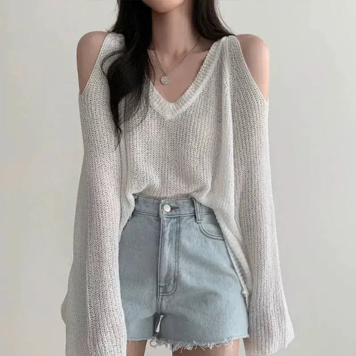 Loose knit sweater with cut-out shoulders and v-neckline