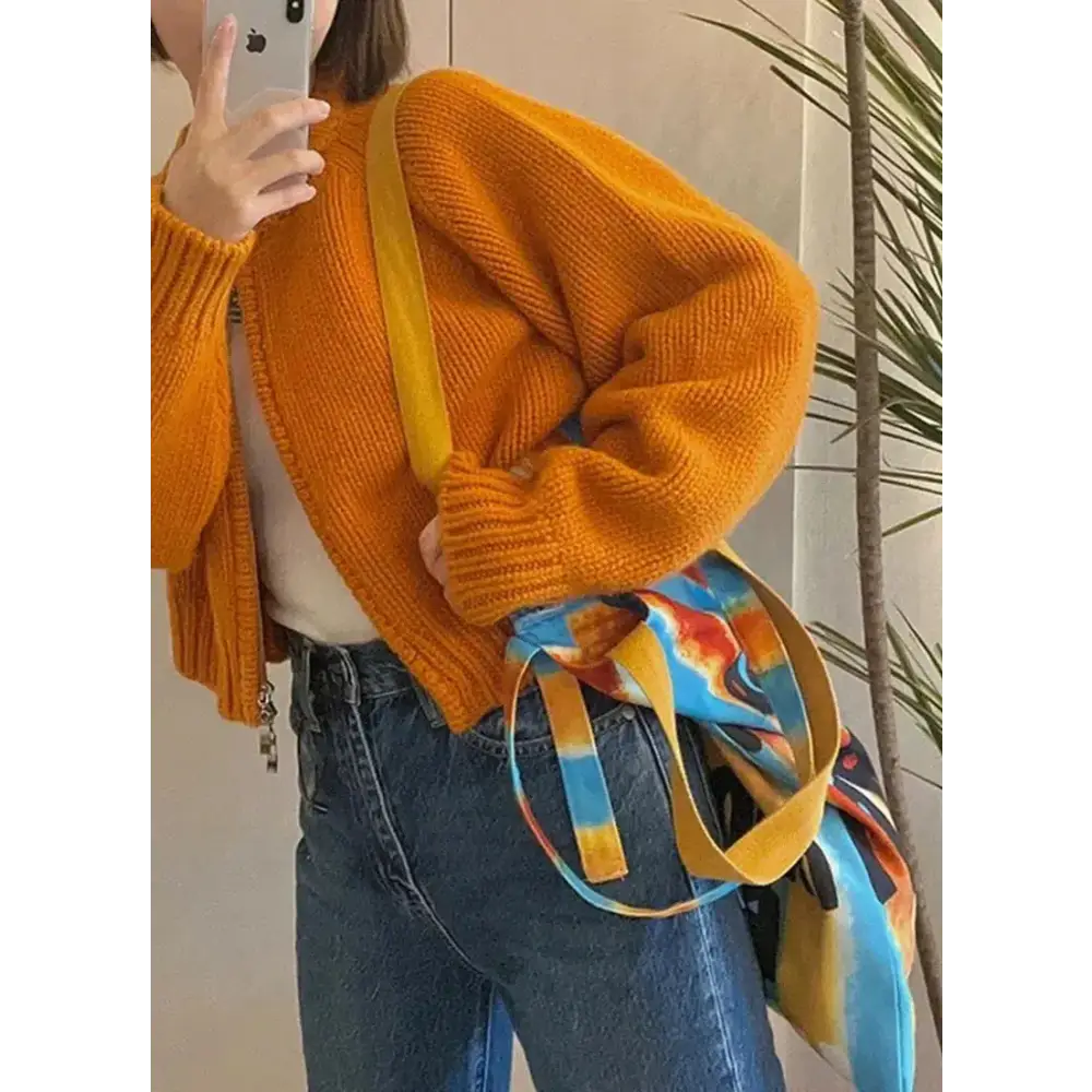 Vibrant solid orange knitted cardigan with crew neck design