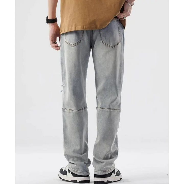 Light wash denim straight leg jeans with rips at the knees