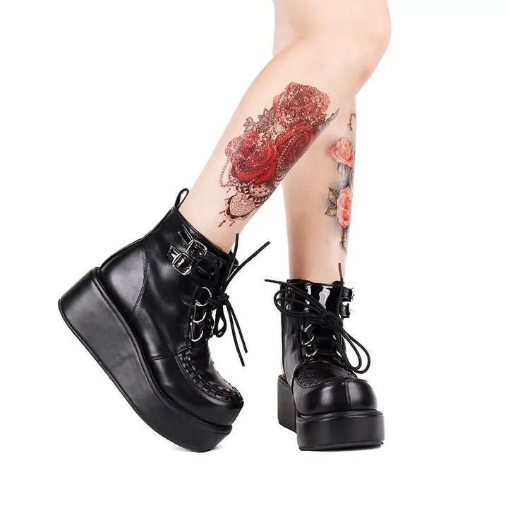 Black platform creeper boots with lace-up design and textured sole