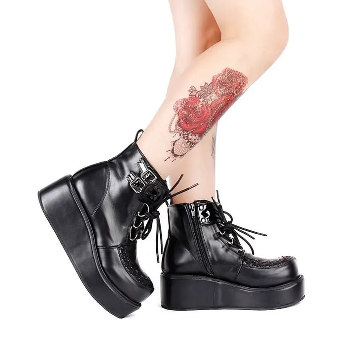 Black platform creeper boots with lace-up design and textured sole